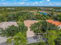 Aerial view of house encircled, showcasing roof and tree coverage within lush surroundings at 790 Shadow Bay Way, Osprey, FL 34229