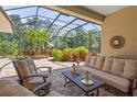 Screened patio with seating area and views of lush landscaping at 790 Shadow Bay Way, Osprey, FL 34229