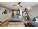 Comfortable living room with stylish decor, wood floors, and stairway access to the second floor at 1655 58Th S Ter # 7, St Petersburg, FL 33712