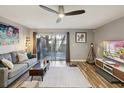 Cozy living room with modern decor, hardwood floors, and sliding glass doors to the backyard at 1655 58Th S Ter # 7, St Petersburg, FL 33712