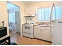 Bright kitchen featuring classic appliances, ample counter space, and natural light from a window at 2075 Canal Dr # L36, Bradenton, FL 34207