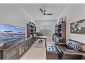 Comfortable home office with custom built-ins, plantation shutters, and a ceiling fan at 328 Aria Dr, Nokomis, FL 34275
