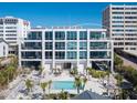 Modern condo building with a pool and beach access, offering luxurious living with stunning ocean views at 6100 Midnight Pass Rd # 401, Sarasota, FL 34242