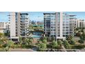 Luxury apartment building with sleek design, palm trees, a pool, and scenic city views at 223 Golden Gate Point # 2A, Sarasota, FL 34236