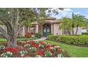 Stunning home featuring lush landscaping, a stone walkway, and a charming front entrance at 2611 Little Country Rd, Parrish, FL 34219