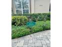 Landscaped yard featuring a sign designating it as 'Yard of the Month' for its curb appeal at 2611 Little Country Rd, Parrish, FL 34219
