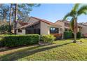 Lovely villa with verdant landscaping, a screened-in patio, and a durable tile roof, perfect for outdoor enjoyment at 5343 Huntingwood Ct # 33, Sarasota, FL 34235