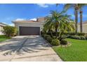 Charming single-story home with a tile roof, lush landscaping, and a spacious driveway at 6914 45Th E Ter, Bradenton, FL 34203
