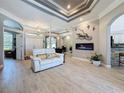Bright living room features elegant tray ceiling, a linear fireplace, and an open floor plan at 16806 5Th Ne Ter, Bradenton, FL 34212