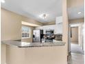 Bright kitchen with stainless steel appliances, granite counters, and a breakfast bar at 1382 Ronald St, North Port, FL 34286