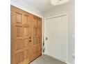 Interior view of a solid wood double front door with sidelight and tile floor at 2299 Riverwood Ct, Sarasota, FL 34231