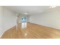 Spacious living room with gleaming hardwood floors and neutral paint color at 2299 Riverwood Ct, Sarasota, FL 34231