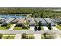 Aerial view of home with lush backyard and nearby lake at 5023 Tobermory Way, Bradenton, FL 34211