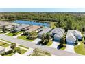 Aerial view of home with lush backyard and nearby lake at 5023 Tobermory Way, Bradenton, FL 34211