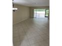 Spacious living room featuring tile floors and sliding glass doors to a screened in patio at 7030 W Country Club N Dr # 128, Sarasota, FL 34243