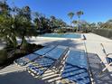 Relaxing pool area with plenty of lounge chairs, perfect for enjoying the sunny weather at 7030 W Country Club N Dr # 128, Sarasota, FL 34243