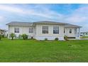 Backyard of home with vinyl siding and manicured lawn, offering a serene outdoor space at 4531 13Th E St, Ellenton, FL 34222