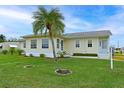 Charming single-story home with well-maintained lawn and a beautiful palm tree in the front yard at 4531 13Th E St, Ellenton, FL 34222