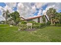 Beautiful condo building with lush tropical landscaping, mature trees, and manicured lawns at 800 S Blvd Of Presidents # 12, Sarasota, FL 34236