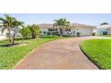Attractive single-Gathering home featuring a well-manicured lawn and tropical landscaping, enhancing the curb appeal at 829 Harbor S Dr, Venice, FL 34285