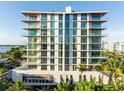 Modern condo exterior with floor-to-ceiling windows, offering stunning views and abundant natural light at 111 Golden Gate Pt # 701Ph, Sarasota, FL 34236