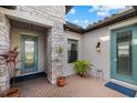 Inviting front entrance with brick pavers, blue door and stone pillar offers a charming welcome to the residence at 2028 Woodleaf Hammock Ct, Bradenton, FL 34211