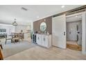An open concept floorplan shows a bar, dining and other living space, with light flooring and modern fixtures at 3902 11Th W Ave, Bradenton, FL 34205