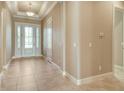 Elegant foyer with decorative ceiling, neutral walls, and tiled floors leading into the home at 4020 Cascina Way, Sarasota, FL 34238