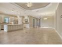 Spacious kitchen with stainless steel appliances, a large island, and seamless flow into the open floor plan at 4020 Cascina Way, Sarasota, FL 34238