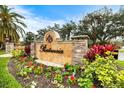 Prestancia community sign surrounded by colorful flowers and greenery, creating an inviting entrance at 7716 Club Ln, Sarasota, FL 34238