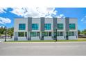 Modern townhome featuring a white and gray exterior with large windows and professional landscaping at 1774 10Th St, Sarasota, FL 34236