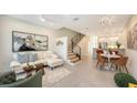 Open-concept living room with modern staircase and neutral decor at 1774 10Th St, Sarasota, FL 34236