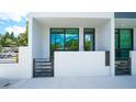 Modern townhouse exterior featuring a gated entry and sleek architectural design under a bright sky at 1778 10Th St, Sarasota, FL 34236