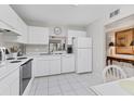 Efficient kitchen with white cabinetry, appliances, and ample counter space, providing a functional cooking area at 542 Lakeside Dr # 542, Bradenton, FL 34210
