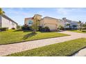 Charming single Gathering home with landscaped yard, brick driveway and two-car garage at 6247 Champions Row St, Bradenton, FL 34210