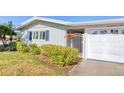 A well-maintained single-story home with lush landscaping, a secure gated entrance, and a convenient attached garage at 7304 11Th W Ave, Bradenton, FL 34209