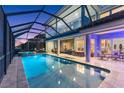 Beautiful backyard with a large pool, spa, screened enclosure, and covered patio for outdoor enjoyment at 1215 Acappella Ln, Apollo Beach, FL 33572