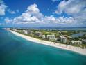 Scenic aerial view showcasing beachfront condos along a pristine coastline with blue ocean waters at 240 Sands Point Rd # 4201, Longboat Key, FL 34228