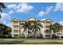 Attractive exterior of condos with private balconies, lush landscaping, and palm trees at 3430 77Th W St # 102, Bradenton, FL 34209