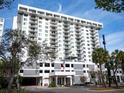 Exterior view of a condominium building with an American flag at 101 S Gulfstream Ave # 10E, Sarasota, FL 34236