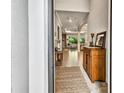 Inviting foyer featuring tile flooring and views into the living area, complete with decorative furnishings and a rug at 17601 Hickok Belt Loop, Bradenton, FL 34211