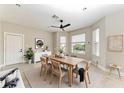 Bright dining room featuring a modern table set, a ceiling fan, and large windows at 1825 Bayshore Dr, Terra Ceia, FL 34250