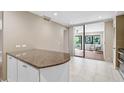 Bright kitchen with white cabinets, granite countertops and view to the Lanai at 304 Pine Run Dr, Osprey, FL 34229