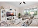 Bright living room, with stylish furnishings, and entertainment center at 727 Holly Rd, Anna Maria, FL 34216