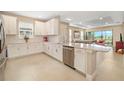 Bright kitchen featuring white cabinets, stainless steel appliances, and a center island at 16127 Fortezza Dr, Bradenton, FL 34211