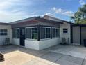 Enclosed patio featuring lots of natural light and cozy seating area at 4122 N Lockwood Ridge Rd, Sarasota, FL 34234