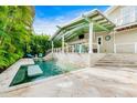 Inviting pool with spa, bar-top seating, and a covered outdoor dining area, perfect for entertaining at 213 84Th St, Holmes Beach, FL 34217