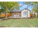 Inviting craftsman home featuring a cozy front porch with wooden pillars, lush lawn, and professional landscaping at 4536 1St N Ave, St Petersburg, FL 33713