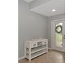 Welcoming entryway with neutral walls, tile flooring, and decorative glass front door with accent table and decor at 8402 Grand Estuary Trl # 101, Bradenton, FL 34212