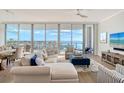 Inviting living room with floor-to-ceiling windows offering panoramic water views and ample natural light at 1155 N Gulfstream Ave # 607, Sarasota, FL 34236